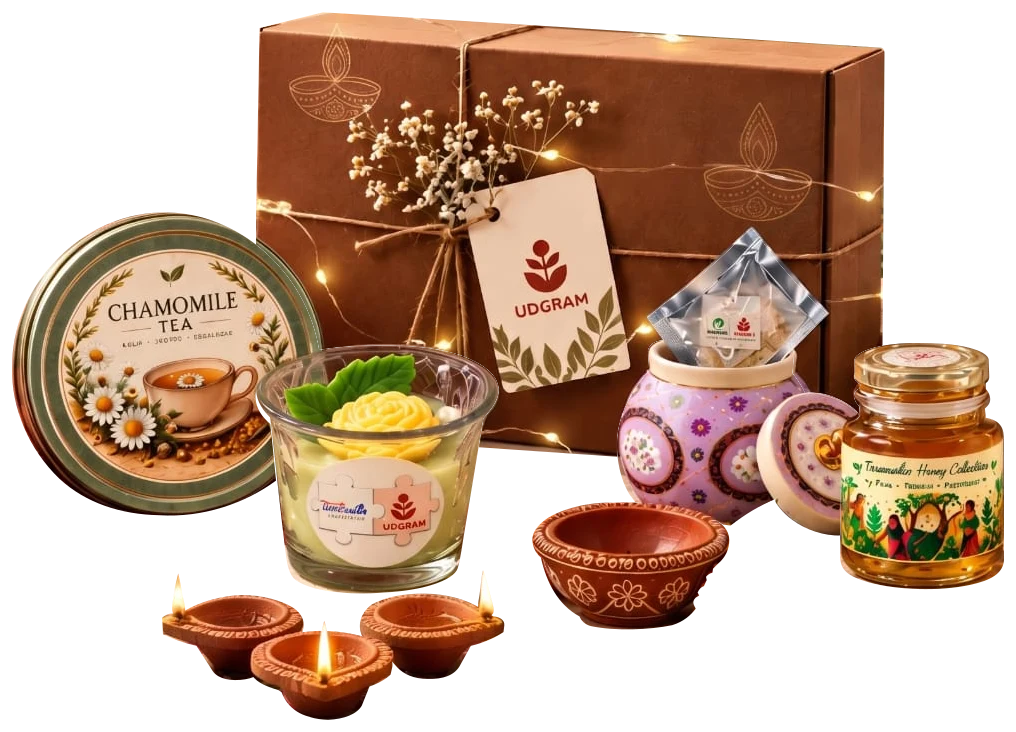Udgram’s festive hamper arranged with honey, chamomile tea, a flower candle and glowing clay diyas